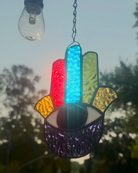 Hand of Fatima stained-glass suncatcher with seven textured chakra colors and an eye in the palm