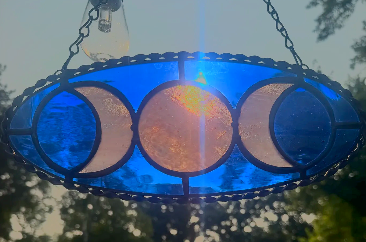 Blue Triple Moon Goddess stained-glass suncatcher with three moon phases in an oval panel