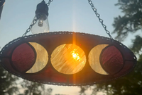 Deep Red Triple Moon Goddess stained-glass suncatcher with three moon phases in an oval panel