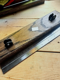 Angled measurement view of a Jacobean-stained wood stand for stained glass
