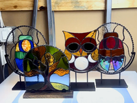 Jacobean-stained wood stand with adjustable clamps shown beside stained glass