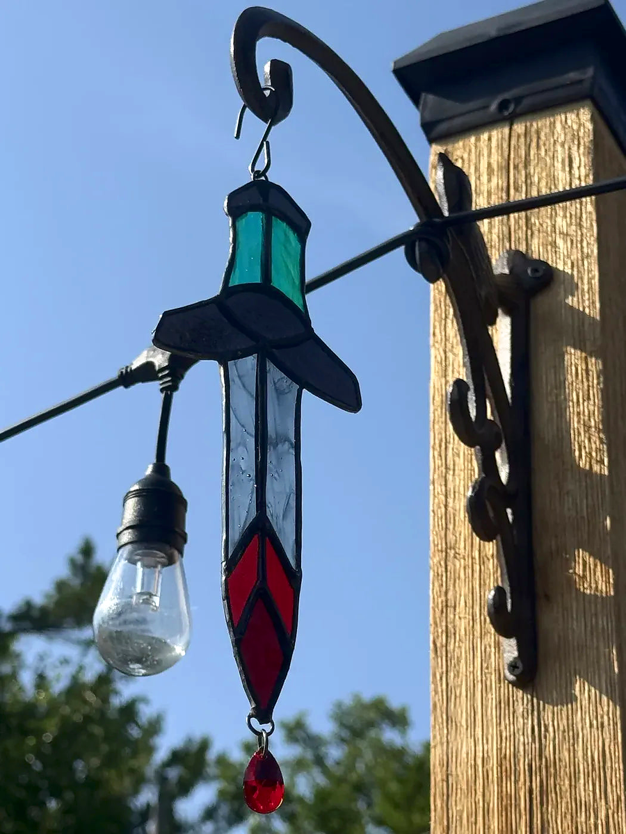 Close-up of the blue-grip Bloody Dagger stained-glass suncatcher with clear smoky blade and red crystal