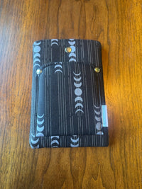 Small padded fabric device sleeve with Moon Phases design, shown upright