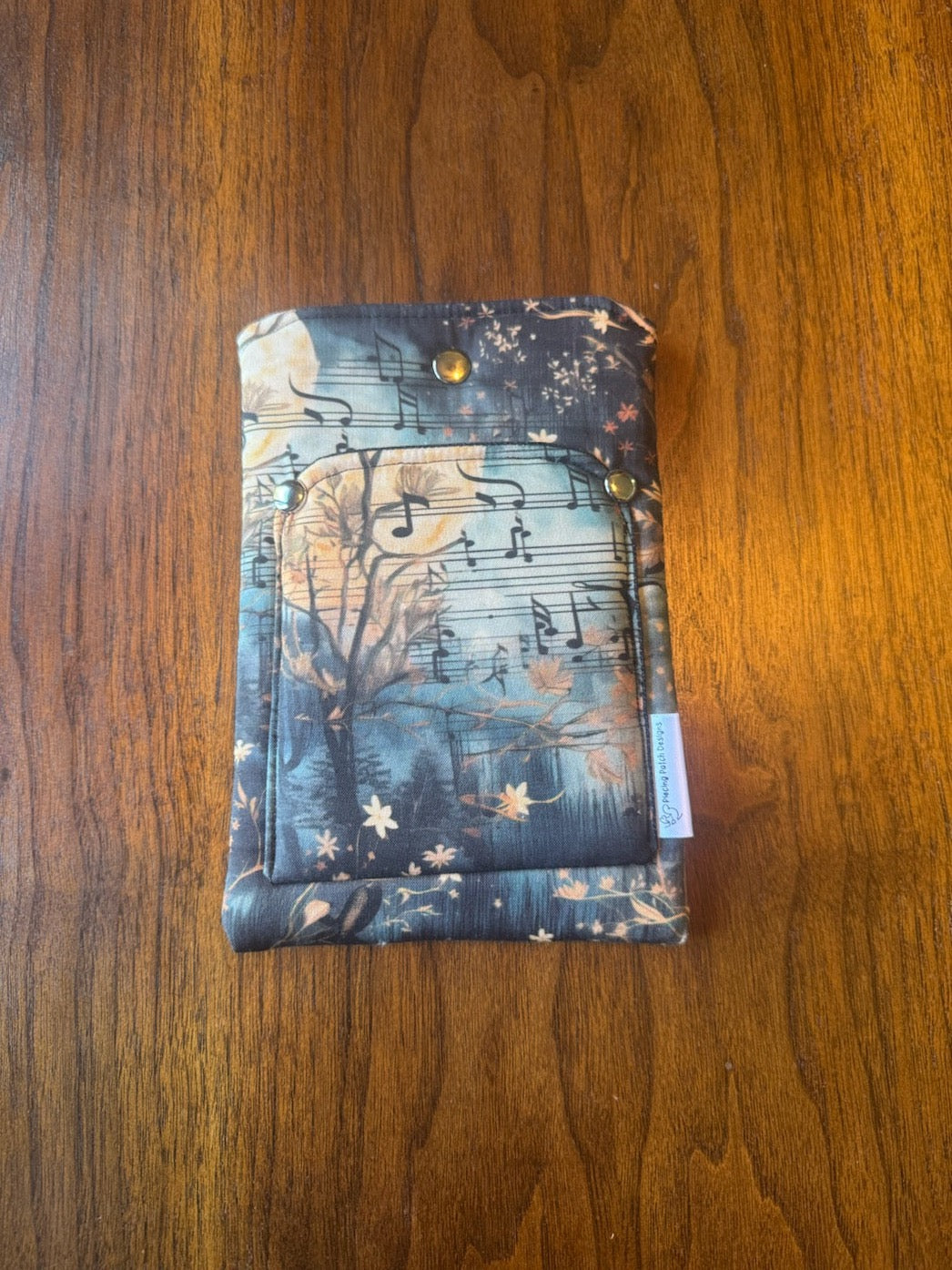 Small padded fabric device sleeve with Moon Song design, shown upright