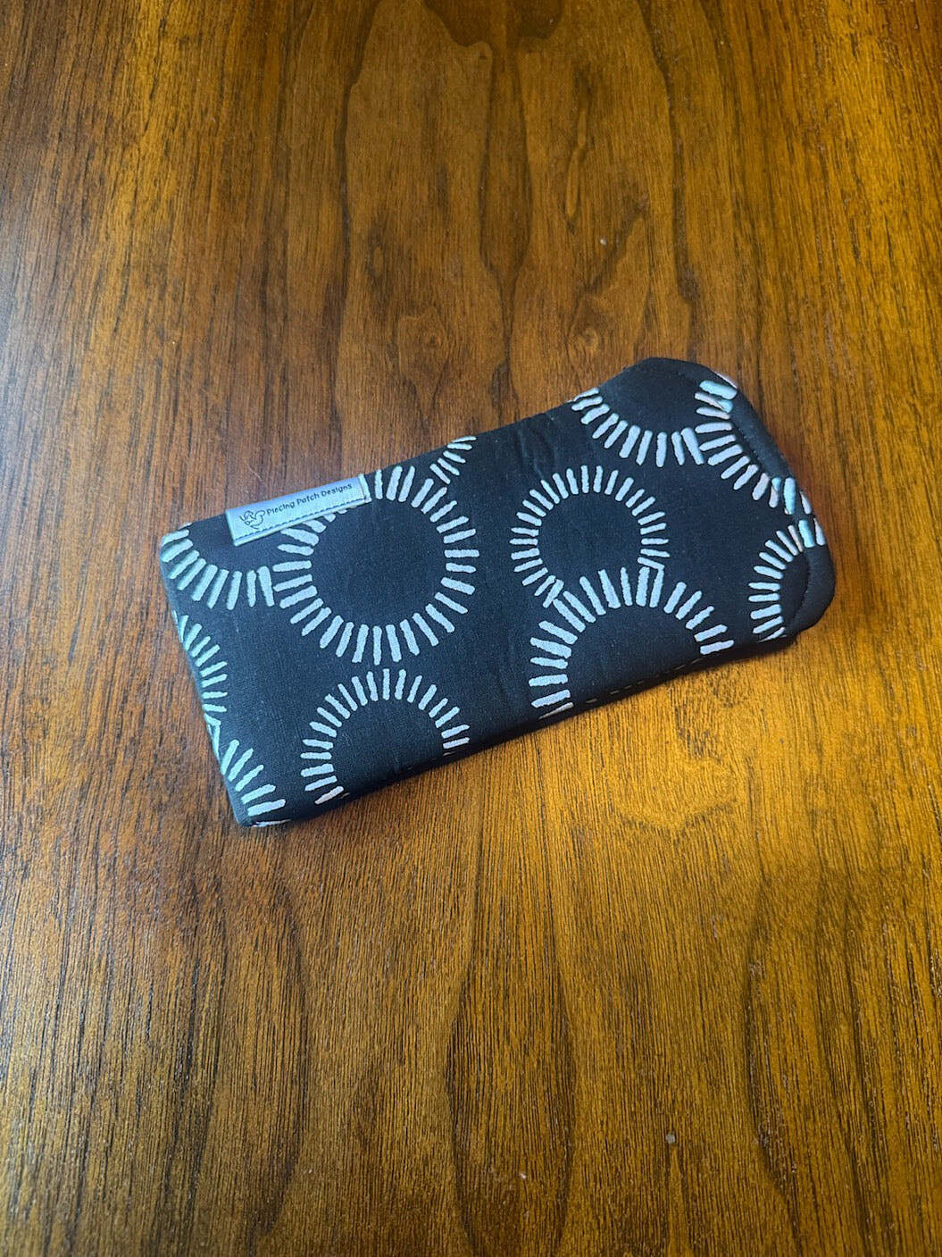 Padded fabric eyeglass case in Black and White Circles design, with built-in lens cloth