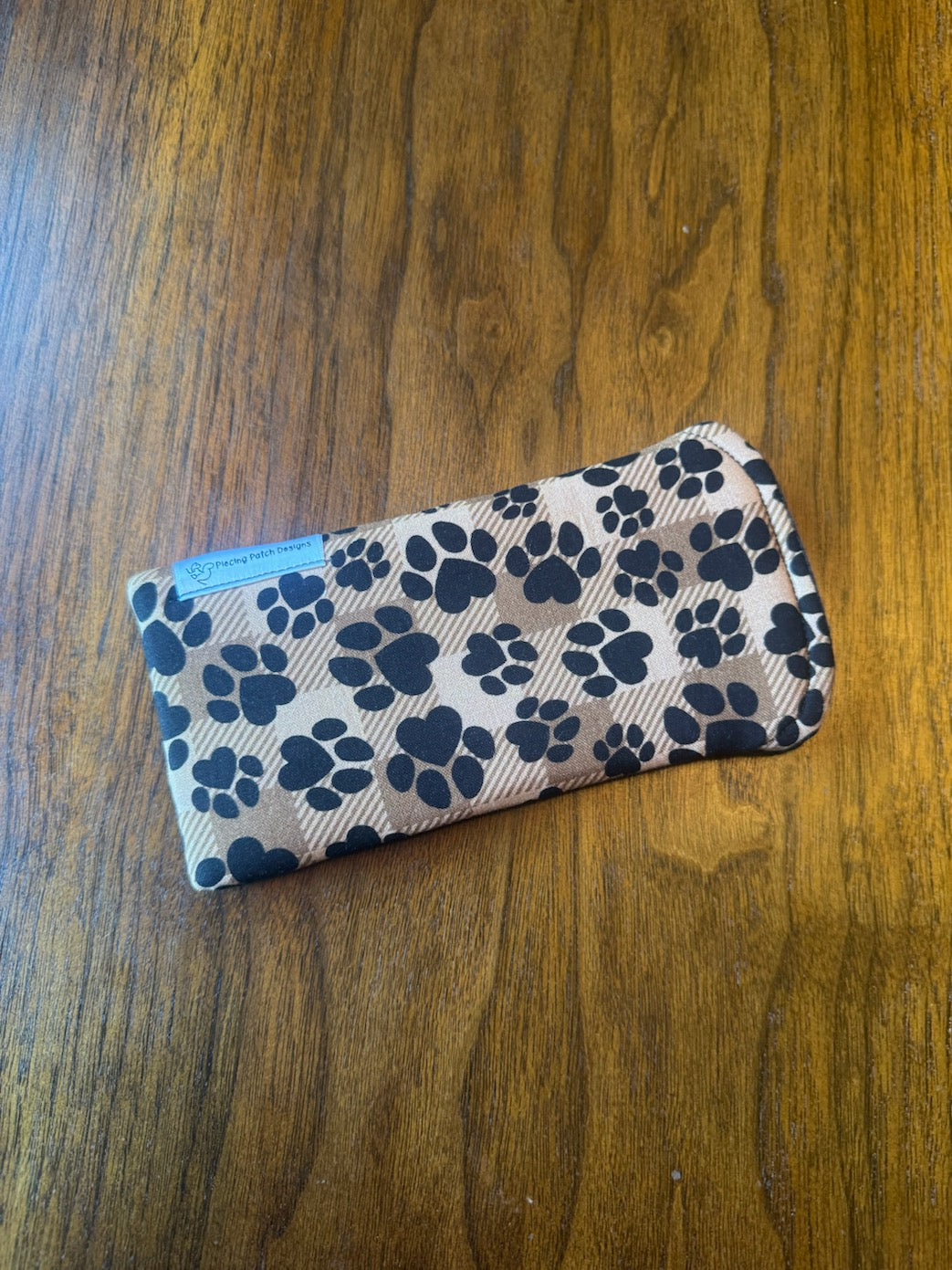 Padded fabric eyeglass case in Heart Puppy Prints design, shown with built-in lens cloth