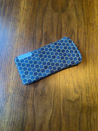 Padded fabric eyeglass case in black, grey, and gold honeycomb metallic print, with built-in lens cloth