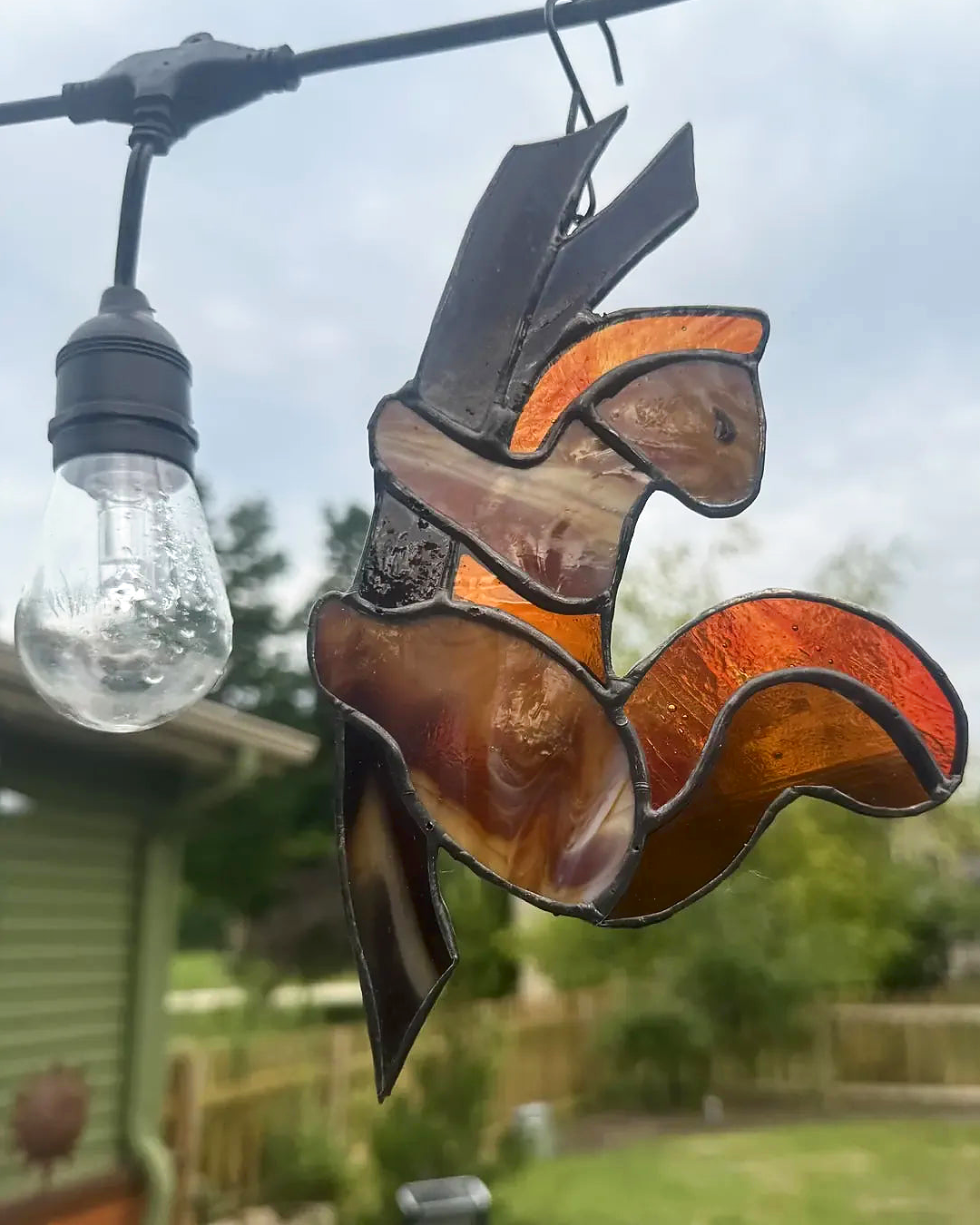 Squire the Squirrel stained-glass suncatcher in warm brown, amber, and orange glass