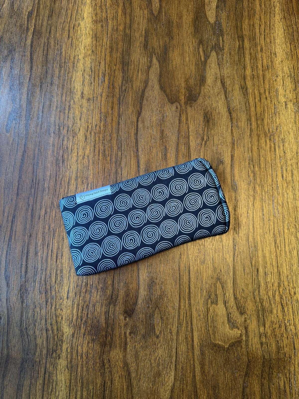 Padded fabric eyeglass case in Silver Swirls design, with built-in lens cloth